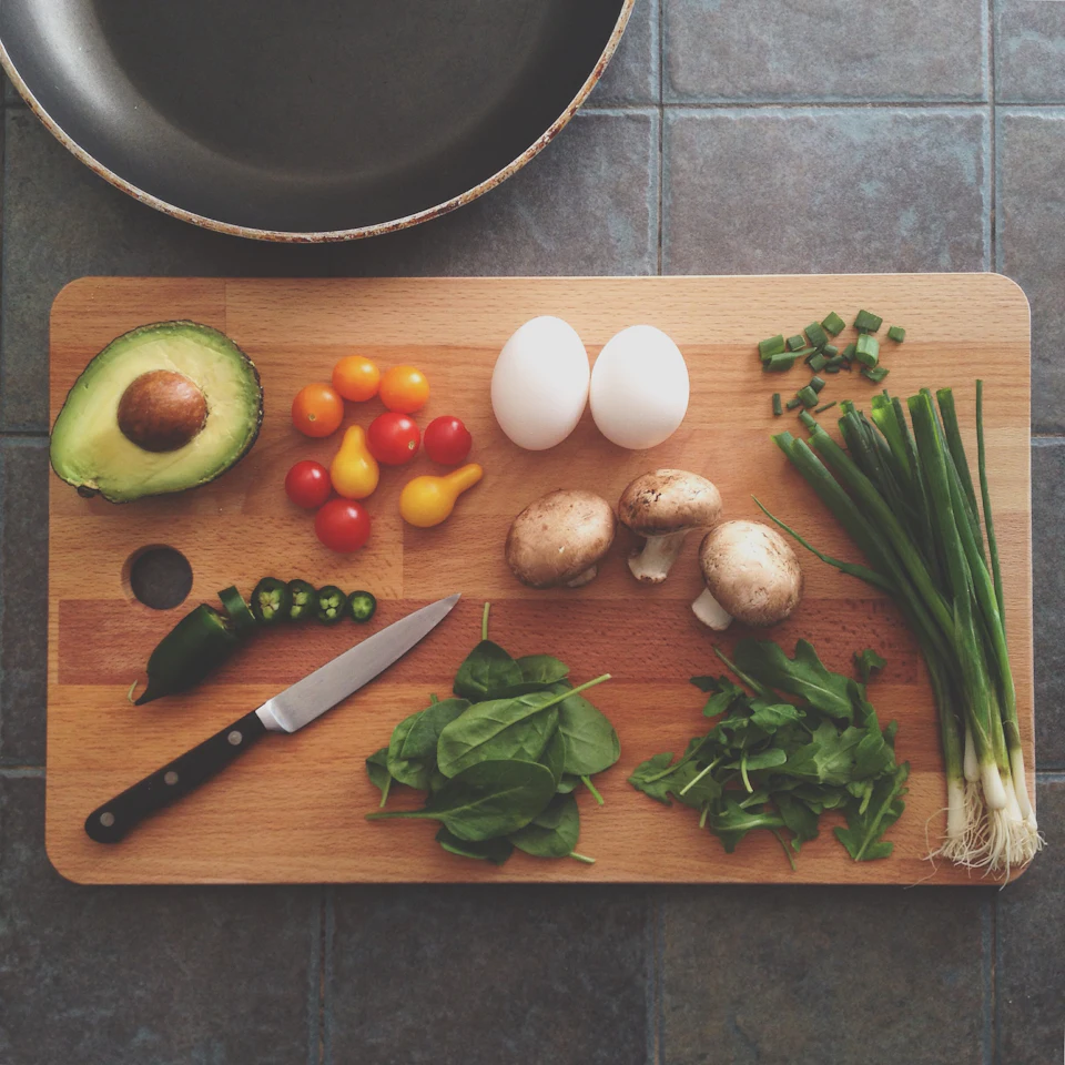 Avocado, tomatoes, eggs, mushrooms, spring onions, and leaves