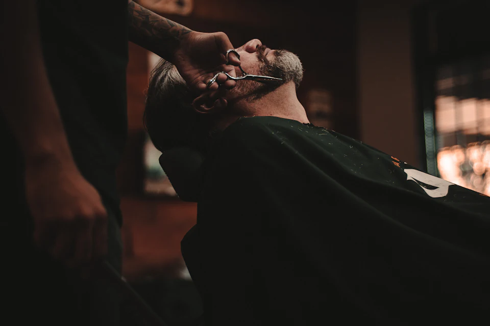 Man sitting on barber's chair