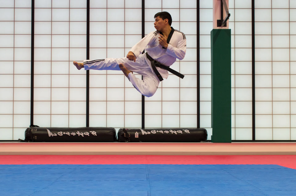 Man doing karate stunts on gym