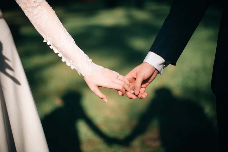 Man and woman holding hands focus photo