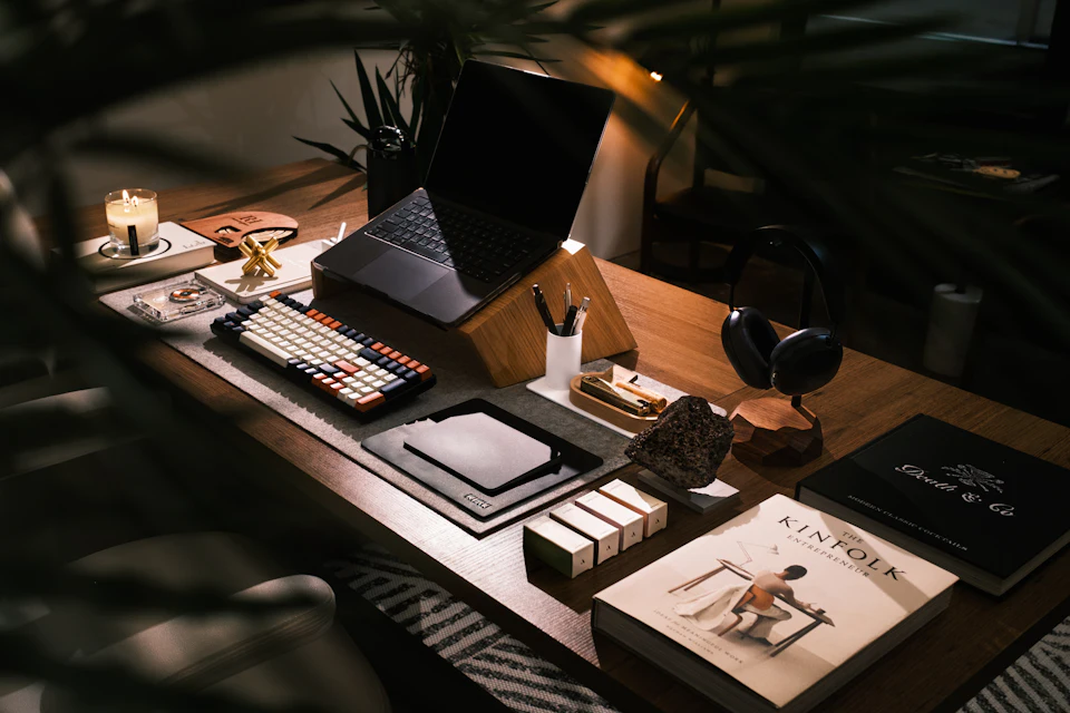 A modern desk setup with laptop and books